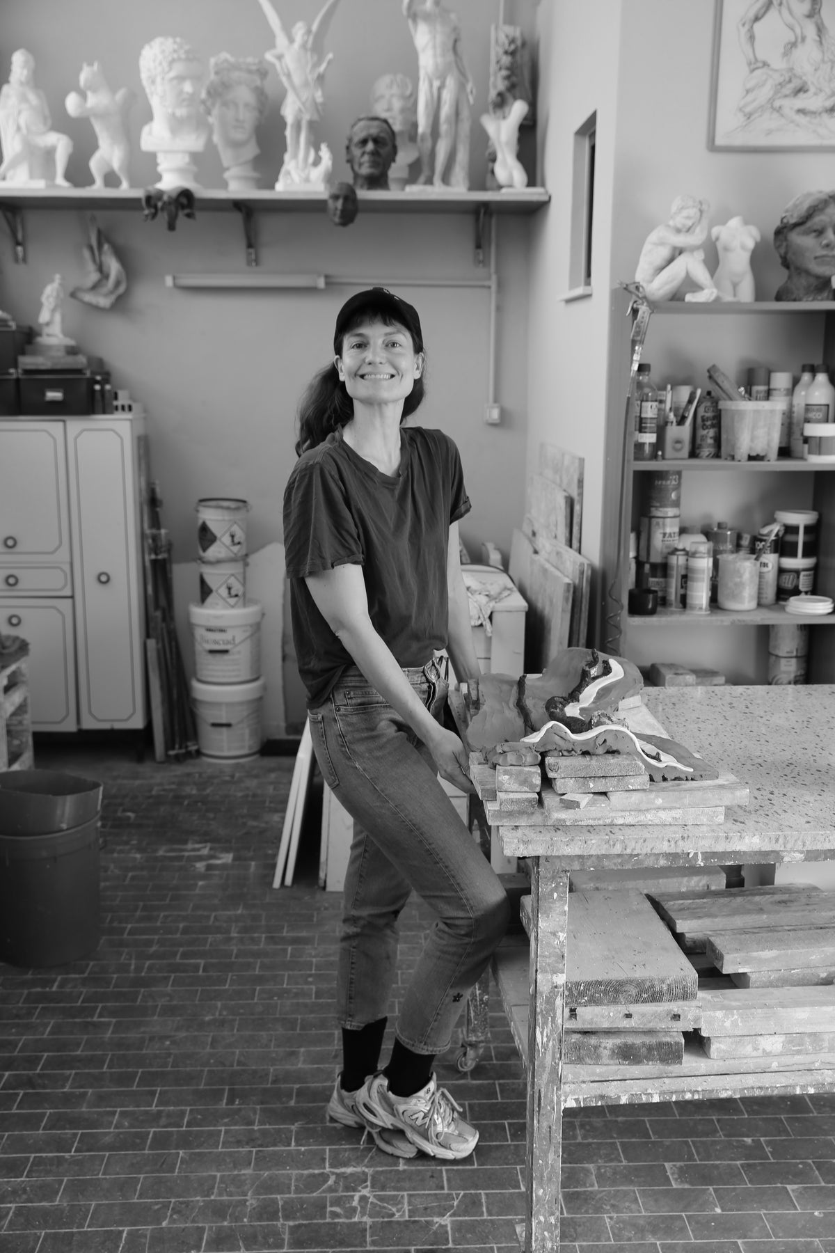 Black and white photo of Julie Laenkholm smiling in her studio.